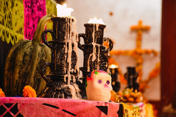 Different elements that are used in the altar of the dead such as bread of the dead, sugar skulls, candles, water and salt to celebrate the day of the dead in Mexico