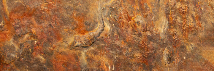 Rust of metals.Corrosive Rust on old iron with a hole. Rusted orange painted metal wall. Rusty metal background with streaks of rust. Old shabby paint.metal rust texture background