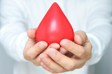 healthy man's hand holding blood symbol Blood Donation Help and Health Concepts
