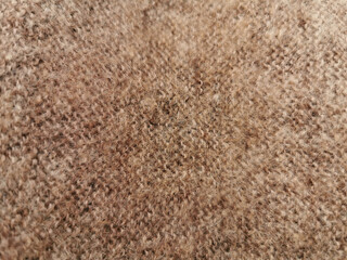Hand-knitted texture close-up.  Natural hand-knitted wool shawl. Warm cozy knitted clothes or handmade plaid, blurred background. Russian down shawl made of goat or sheep wool