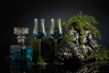 Blue gin on a black reflective background.