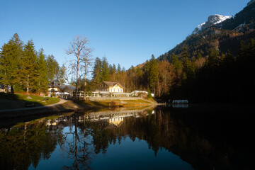 Blausee , beautiful turquoise lake and Blausee Hotel and Spa in  Kandergrund during autumn , winter morning : Blausee , Switzerland : December 4 , 2019