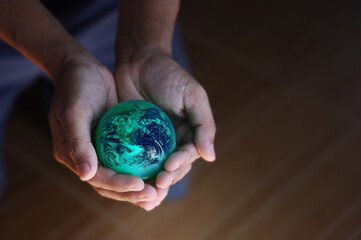 Globe was holding in human hands. Earth day. Energy saving concept, Elements of this image furnished by NASA