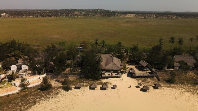 Descending Aerial Shot Revealing The Beachfront Resorts On Tofo Beach