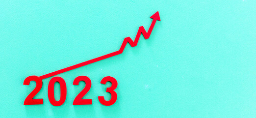 2023 Economic growth or financial crisis. New Year number and red arrow up.