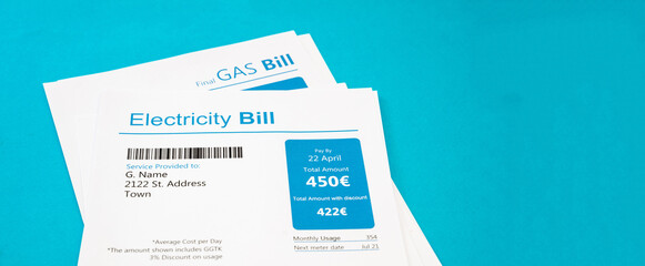 Heating and energy cost concept. Electricity and gas bills on blue