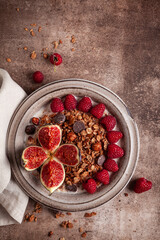 Chocolate granola with almond milk, raspberries, figs and honey.