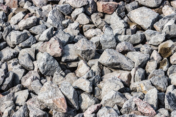 Road construction stone gravel granite stone Crushed rock close up. Small rocks ground. Crushed stone road building material gravel texture. Small stone construction material rock.