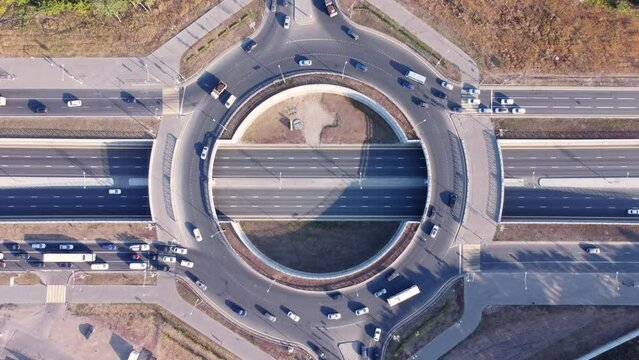 Aerial top down view of a multi-level road junction with car traffic.