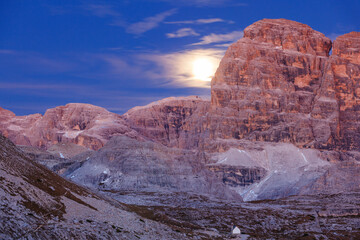 Moonrise in the mountain with a small chapel in a ravine