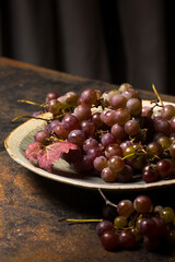 juicy grapes in a plate on a metal background
