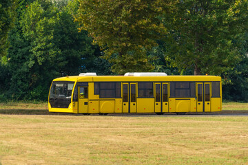 Yellow shuttle bus to transport people at the airport to the flight.