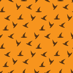 Fototapeta na wymiar Brown witch hats seamless pattern on Orange background, Halloween witch cap illustration background