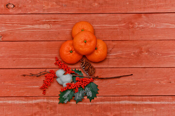 still life with fruit . orange, lemon, tangerine. wooden background. fruit concept.Christmas tree with twigs-evergreen pine needles, cones.space for text.
