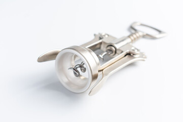 Shiny metal wine bottle openers on a white background