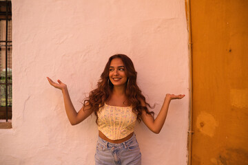 Beautiful young woman with long curly hair on a white background makes different expressions. Laughter, hate, sadness, smile, tired, admiration, surprise, happiness. Concept different expressions.