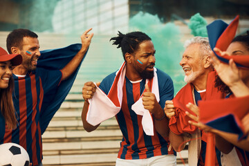Group of happy sports fans celebrate victory of their favorite team during soccer championship.