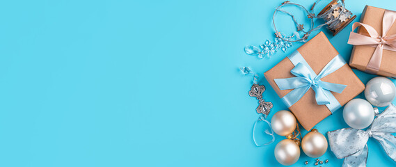 Festive background with Christmas balls, gifts and decorations on a blue background. Merry Christmas and Happy New Year. Top view, copy space
