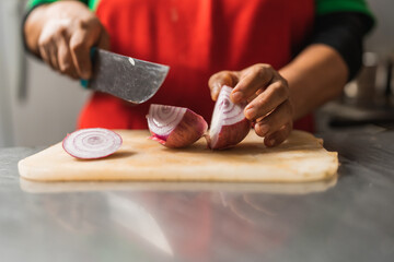 Cook chopping onions in a kitchen