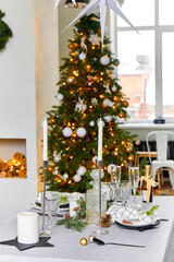 Light festive Christmas interior, set table for a festive dinner