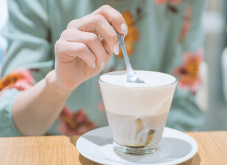 girl drinking latte coffee in a cafe