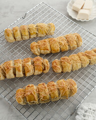 Bolen Pisang is a light dish made from bananas covered in rolled sheets of pastry dough with cheese topping

