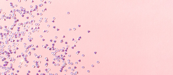 Banner with tiny silver crystal confetti on a pink pastel background. Glowing concept with place for text.