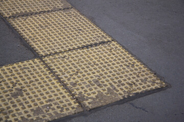 Tactile tiles on the sidewalk. For the blind