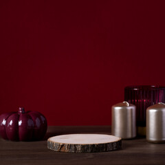 Empty wooden podium and ceramic pumpkin with golden candles for autumn product presentation