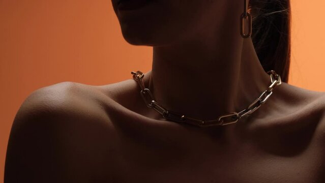 Jewelry on the neck of the model close-up.
