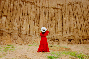 Women and landscape of soil textures eroded sandstone pillars, columns and cliffs, natural erosion of water and wind, Sao Din Na Noi, Hom Chom, Khok Suea at sri nan national park in Nan Province.