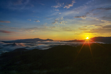 Aerial view Beautiful  panorama of morning scenery Golden light sunrise And the mist flows on high mountains forest. Pang Puai, Mae Moh, Lampang, Thailand.