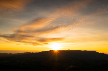 Aerial view Beautiful  panorama of morning scenery Golden light sunrise And the mist flows on high mountains forest. Pang Puai, Mae Moh, Lampang, Thailand.