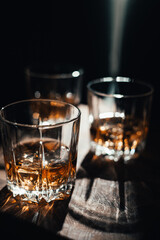 Whiskey with in glasses, rustic wood background, copy space