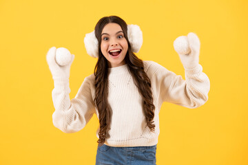 Teenager child santa girl in fur sweater, christmas ball isolated on yellow background. Happy New Year, celebration holiday concept. Excited face. Amazed expression, cheerful and glad.