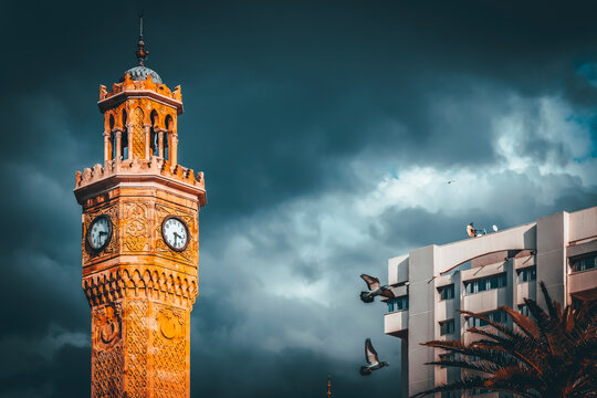 symbol of izmir city, ancient clock tower of symrna with birds and clouds on sky