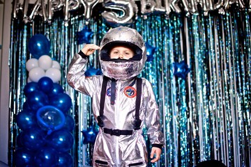 Portrait of a young little caucasian boy of five years old in a astronaut costume on the happy...