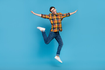 Fototapeta na wymiar Full length photo of crazy energetic person arms wings fly jump isolated on blue color background