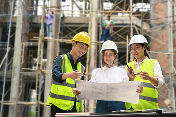 Specialists and team of civil engineer working, checking plan together at construction site