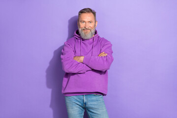 Fototapeta premium Portrait photo of pensioner old attractive man wear stylish casual hoodie crossed hands professional business isolated on purple color background