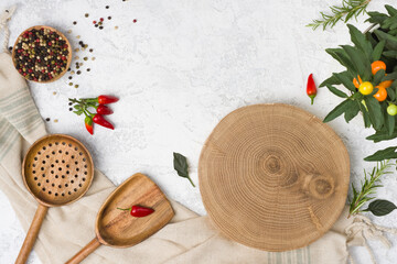 Empty wooden platter and cooking utensils on kitchen table background