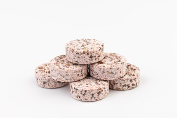 Heap of medicine colored pills, tablets on a white background