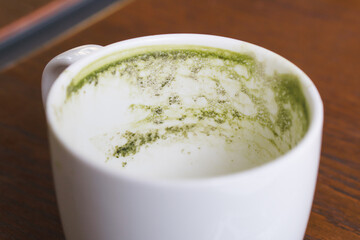 Mug have leftover green tea dry stain before clean.
