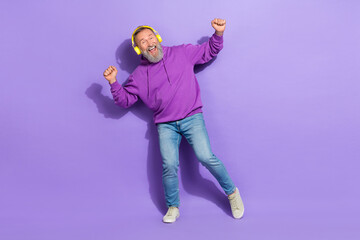 Photo of positive pensioner old man dressed purple hoodie headphones have fun dancing listen songs...