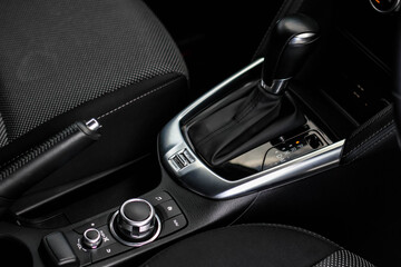 Plakat automatic transmission shift selector in the car interior. Closeup a manual shift of modern car gear shifter. 4x4 gear shift 