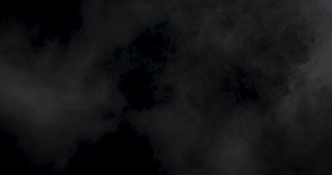 Soft fog haze on dark background. Realistic atmospheric gray smoke on black background. Abstract Fog cloud. Filmed with RED camera.