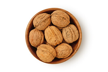 Shelled walnuts in wooden bowl on white background