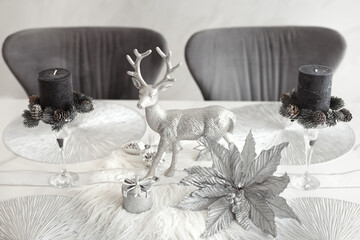 Elegant christmas table decorations in gray and silver colors for winter holidays