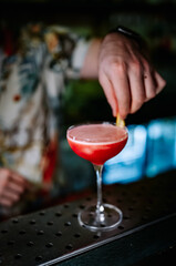 man hand bartender making sweet and sour refreshing cocktail on the bar counter