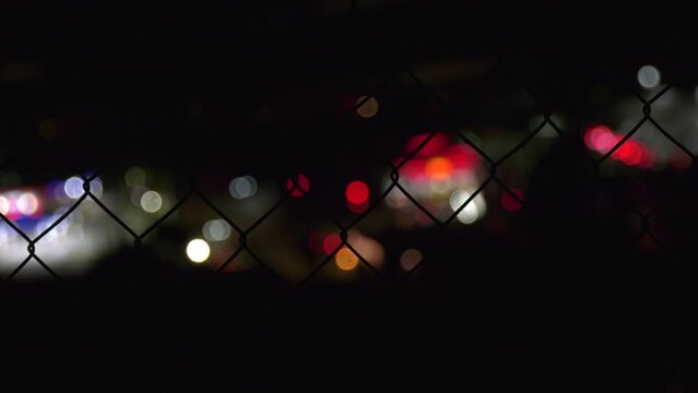 Bokeh View of city lights through a fence